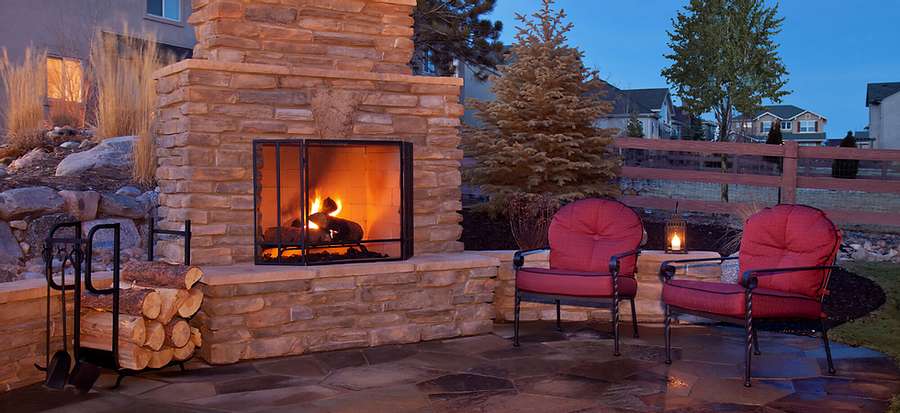 outdoor fireplace with outdoor furniture to the right