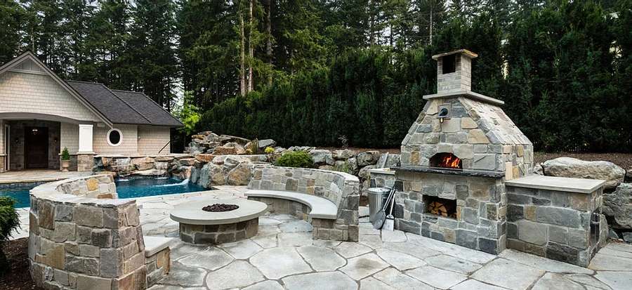 Outdoor pizza oven near pool